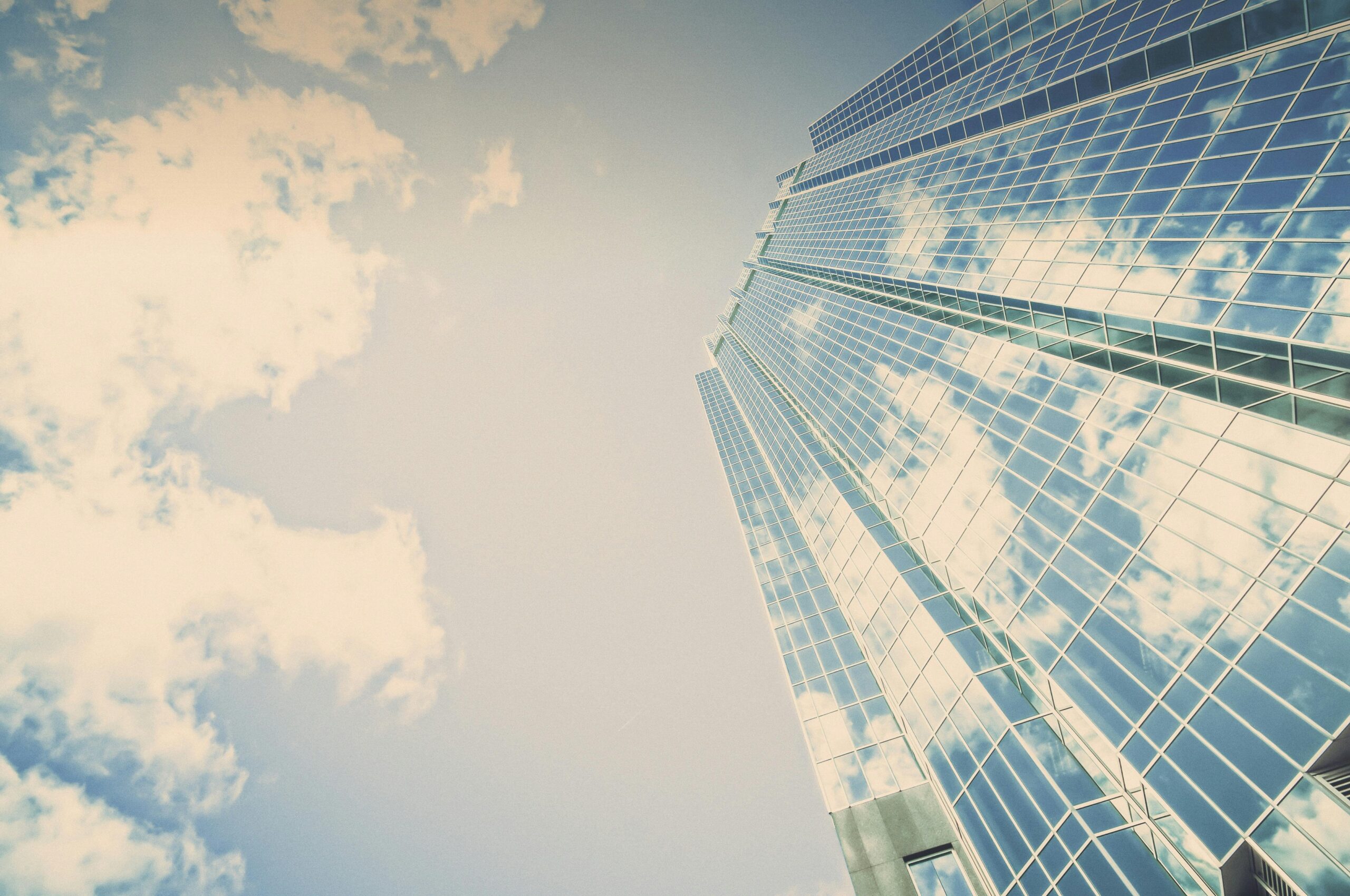 a tall modern skyscraper taken from the ground to represent how cybersecurity can help business growth