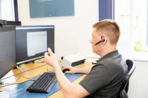 Danny, Comprendo tech director, at his screen on an IT support call