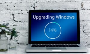 Open laptop showing a Windows update on the screen.