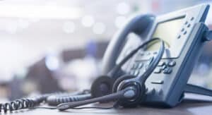 A telephone and headset representing an IT support team